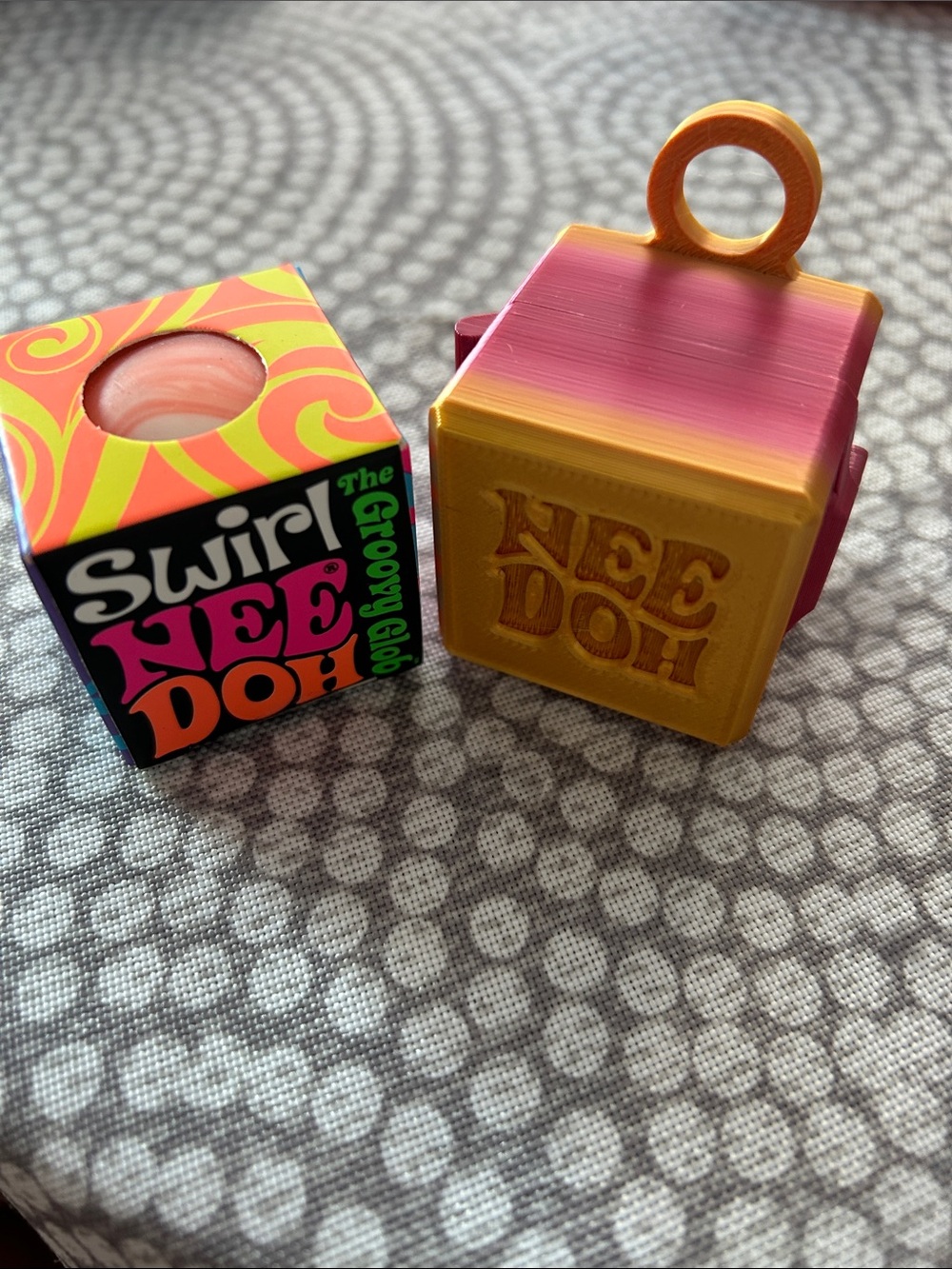 Orange NEEDOH groovy glob SwirlToy - with 3D printed Gold keychain carrying case